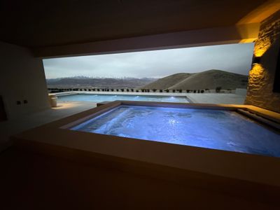 An indoor pool, finished, seen through the window at night